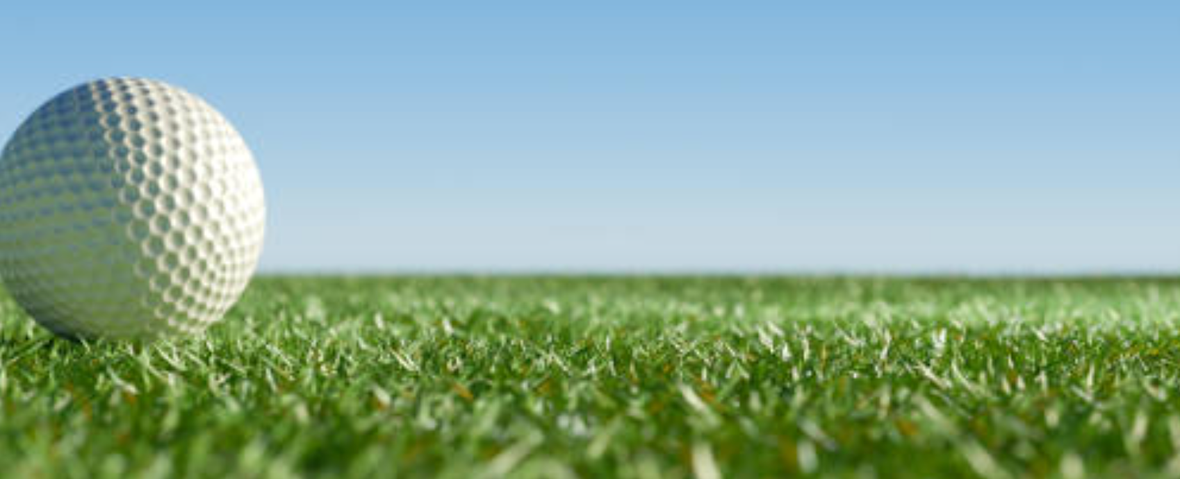 A scenic golf course fairway with elevation change and a water hazard